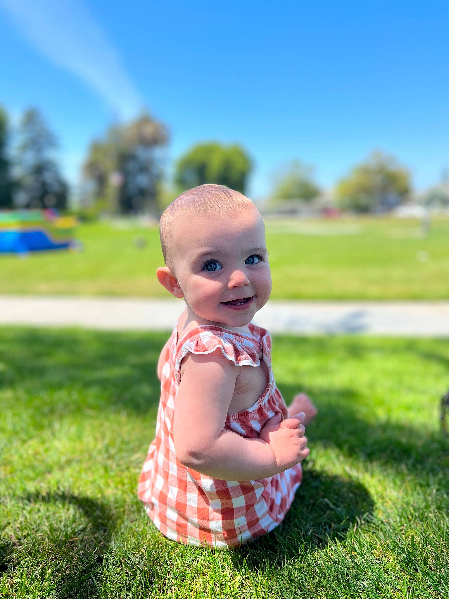 Emilia is registered to the contest to win money with this photo: baby, baby_toddler_clothing, child, fun, grass, grass_family, grassland, happy, landscape, lawn, leisure, meadow, people_in_nature, person, plaid, plant, recreation, sky, sunlight, toddler