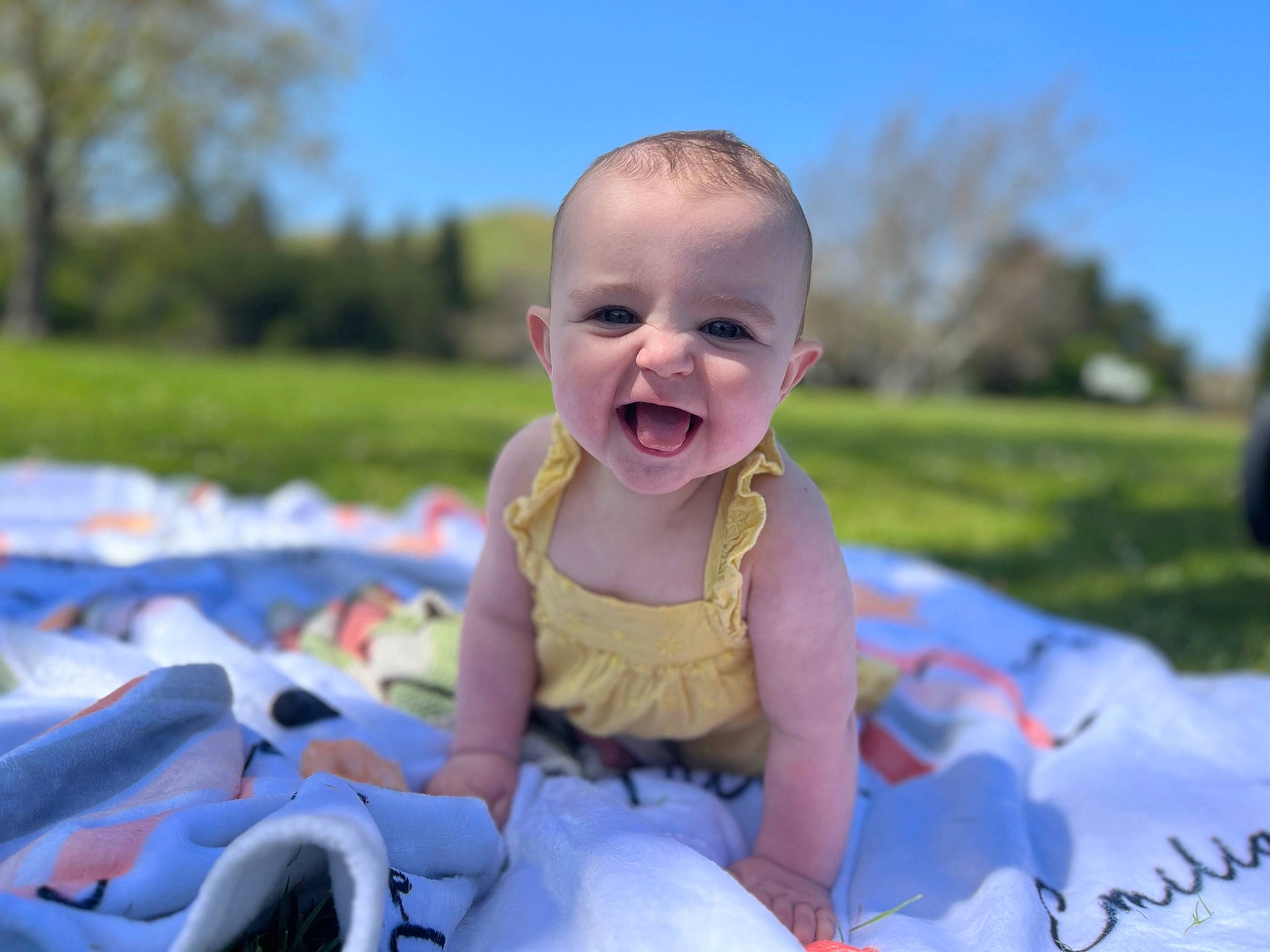 Emilia joined the competition — help win amazing prizes! baby, baby_laughing, baby_toddler_clothing, child, dress, facial_expression, fun, grass, happy, iris, joy, leisure, people, people_in_nature, person, plant, recreation, sky, smile, summer