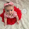 baby, child, tutu, headband, pink, red, cherry_pattern, cute, portrait, soft_blanket, white, infant, smiling, looking_up, sitting, clothing, adorable, indoor, person, baby_fashion