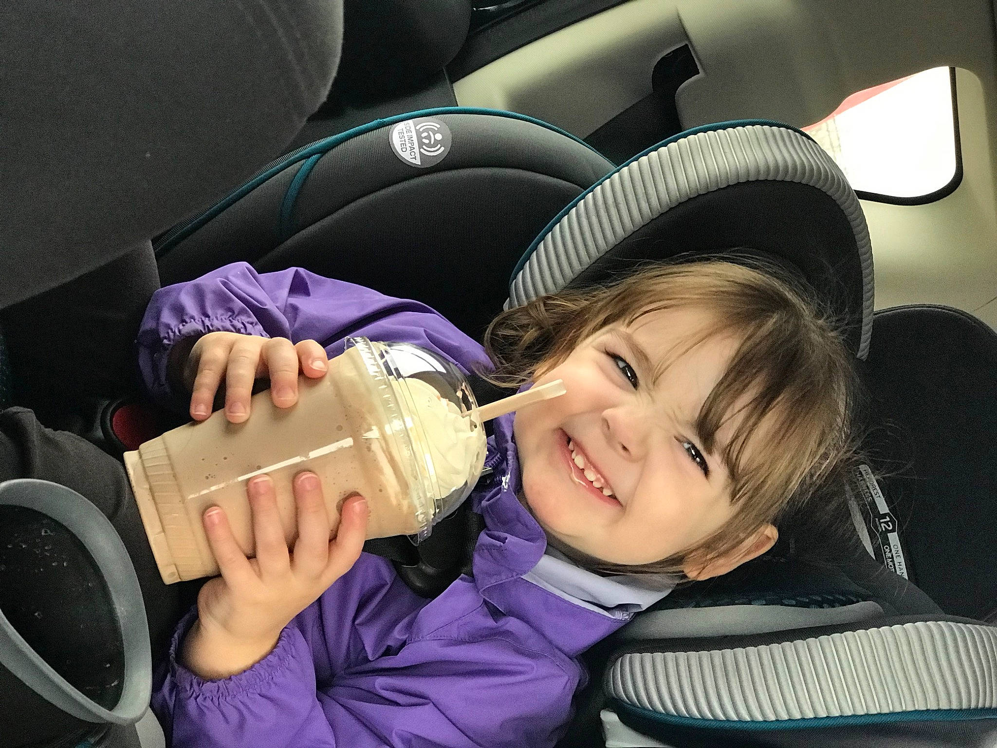 Katrina is registered to the contest to win money with this photo: auto_part, automotive_design, beauty, camera_lens, car, car_seat, car_seat_cover, child, comfort, finger, flash_photography, gesture, hand, head_restraint, joy, motor_vehicle, person, personal_luxury_car, smile, steering_wheel