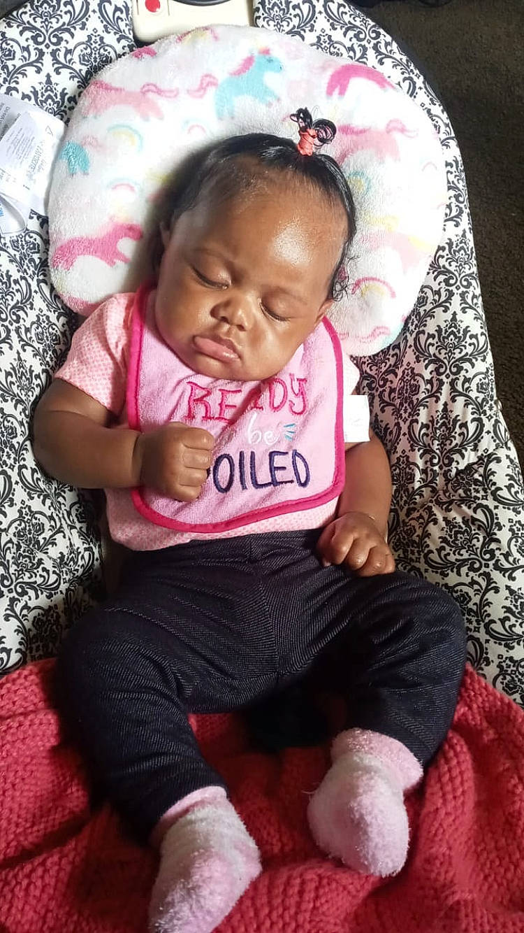 Journie is registered to the contest to win money with this photo: baby, baby_toddler_clothing, cheek, comfort, eye, face, facial_expression, finger, hairstyle, hand, head, human, lip, mammal, organ, person, pink, product, skin, sleeve