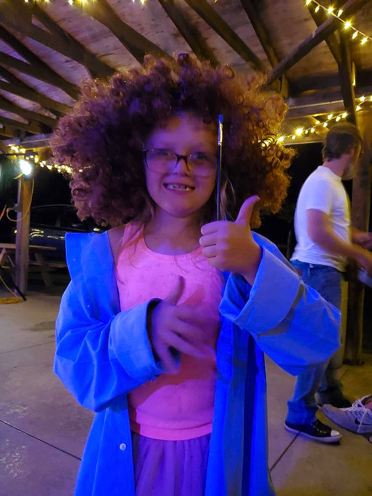 Regan is registered to the contest to win money with this photo: costume, electric_blue, entertainment, event, formal_wear, fun, fur, gesture, glove, happy, jewellery, joy, leisure, magenta, night, party, person, purple, recreation, smile
