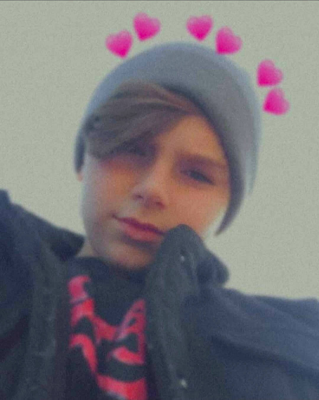 Dawson is registered to the contest to win money with this photo: bangs, black_hair, cap, ear, eyebrow, eyelash, forehead, fun, gesture, happy, headwear, jaw, knit_cap, lip, magenta, neck, nose, pattern, person, pink