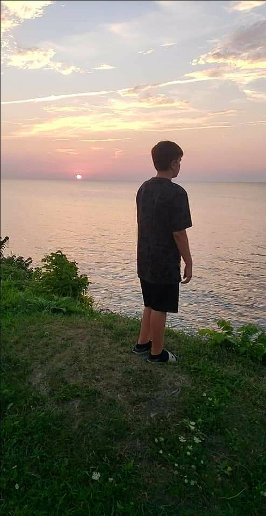 Dawson joined the competition — help win amazing prizes! calm, cloud, coastal_and_oceanic_landforms, flash_photography, grass, happy, horizon, lake, landscape, leisure, people_in_nature, person, plant, shorts, sky, summer, sunrise, sunset, travel, tree