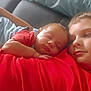 Kélyo participe au concours pour gagner de l'argent avec cette photo : arm, baby, blue_pants, caring, child, closeup, couch, face, family, head, indoor, peaceful, red_shirt, relaxation, resting, siblings, skin, sleeping, soft_light, tenderness
