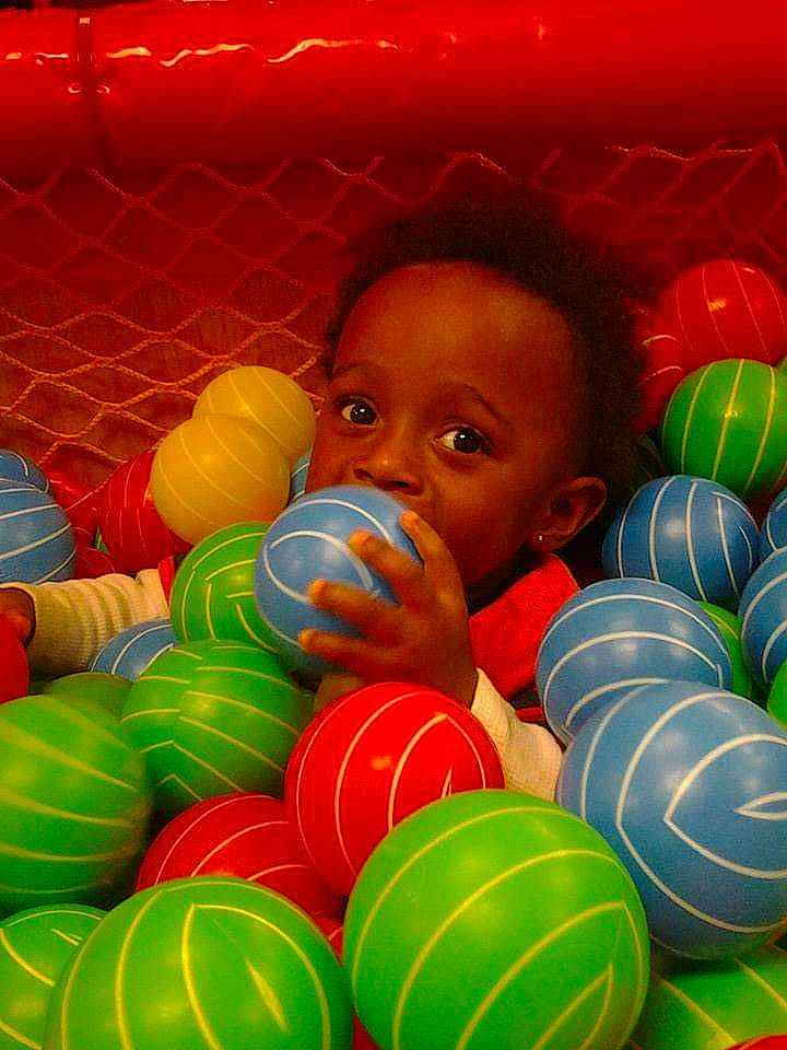 Akeem is registered to the contest to win money with this photo: art, baby, baby_toys, ball, ball_pit, child, circle, event, fun, happy, leisure, light, party, party_supply, person, play, recreation, red, sweetness, toddler