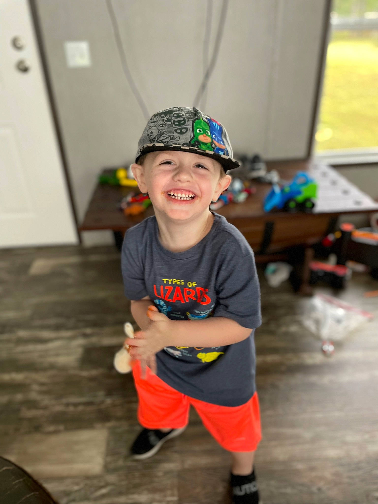 Lawson is registered to the contest to win money with this photo: baseball_cap, cap, child, costume, event, fashion_accessory, fictional_character, floor, flooring, fun, happy, headwear, joy, leisure, party_supply, person, personal_protective_equipment, recreation, room, shorts