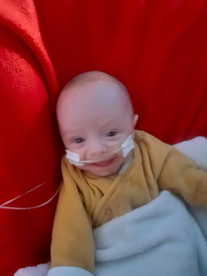 Riley participe au concours pour gagner de l'argent avec cette photo : baby, baby_toddler_clothing, carmine, cheek, child, comfort, eye, flooring, fun, fur, happy, iris, linens, nose, person, room, sitting, sleeve, smile, toddler