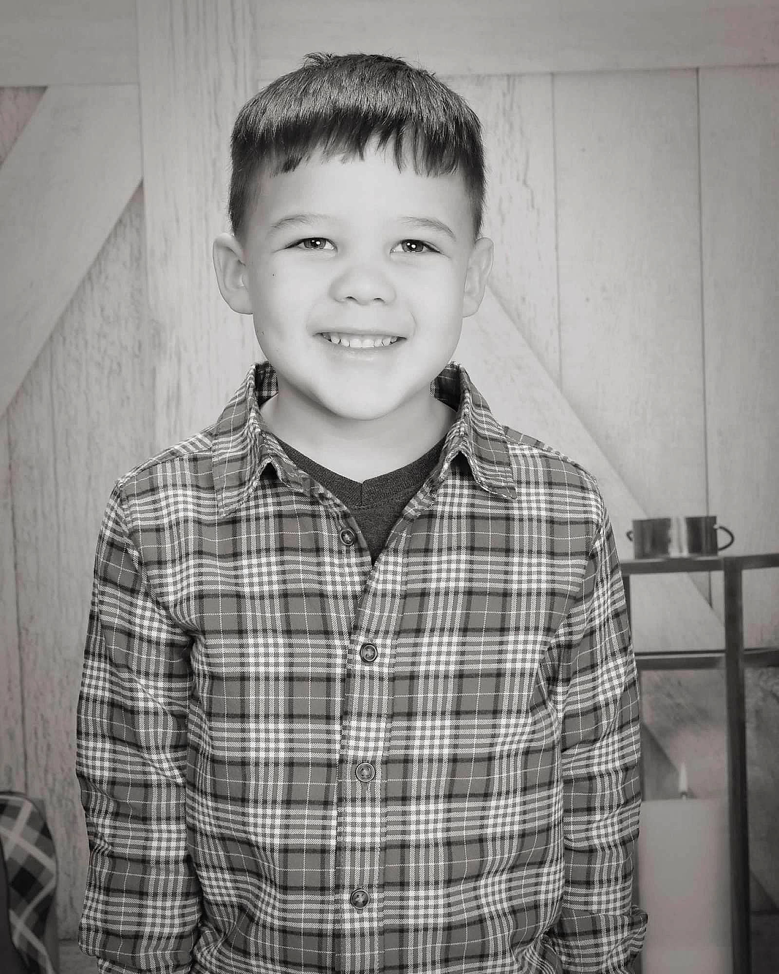 Ryker is registered to the contest to win money with this photo: black_and_white, child, collar, cool, dress_shirt, face, flash_photography, fun, happy, joy, monochrome, monochrome_photography, pattern, person, plaid, sitting, sleeve, smile, standing, style