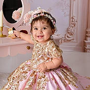 Nayeli is registered to the contest to win money with this photo: baby, child, girl, smile, dress, pink, gold, embroidery, headband, jewelry_box, vanity_table, flower, decor, indoor, portrait, happy, cute, cute_baby, celebration, fashion