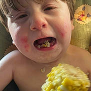 Karter joined the competition — help win amazing prizes! child, corn, food, eating, face, red_cheeks, mouth, hand, closeup, messy, skin, hair, indoor, background, cartoon, clothing, person, young, expression, seat