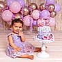 baby, balloons, birthday, cake, cake_smash, celebration, child, cute, decorations, dress, floor, flower_crown, frosting, happy, lavender, pink, portrait, purple, sitting, smiling