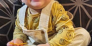 Zayne joined the competition — help win amazing prizes! toddler, child, smiling, yellow_shirt, overalls, socks, winnie_the_pooh, couch, patterned_cushion, happy, indoor, person, seated, cute, young_child, playful, small_object, corduroy, casual_clothing, home