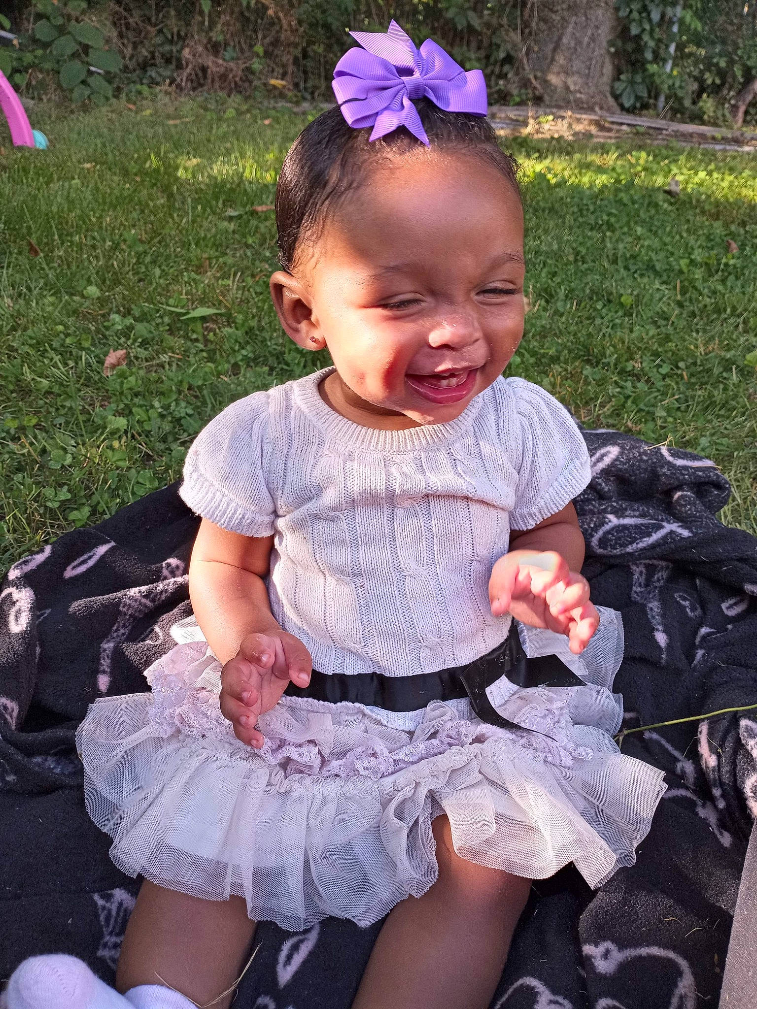 Neahmani is registered to the contest to win money with this photo: baby_toddler_clothing, beauty, blue, child, dress, embellishment, grass, hairstyle, happy, iris, person, photograph, pink, plant, purple, skin, sleeve, smile, snapshot, toddler