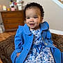 Mahalia is registered to the contest to win money with this photo: baby, clothing, coat, couch, dress, face, furniture, happy, head, knitwear, longsleeve, pants, person, photography, portrait, sitting, sleeve, smile, sweater, wood