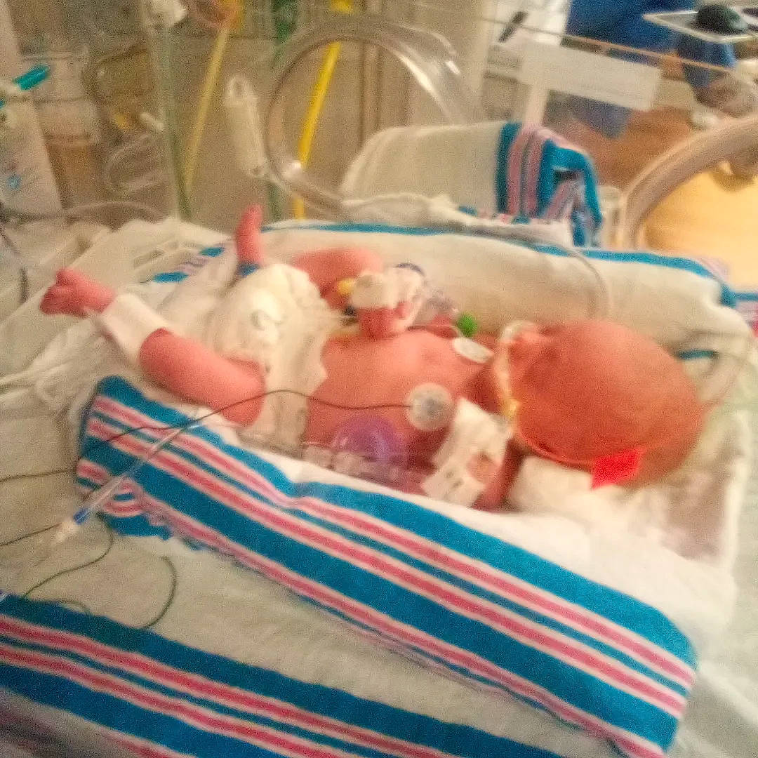 Evelynn is registered to the contest to win money with this photo: baby, baby_products, baby_safety, baby_toddler_clothing, bedding, blanket, child, cloud, comfort, event, health_care, hospital, hospital_bed, infant_bed, linens, medical, person, plastic, room, service