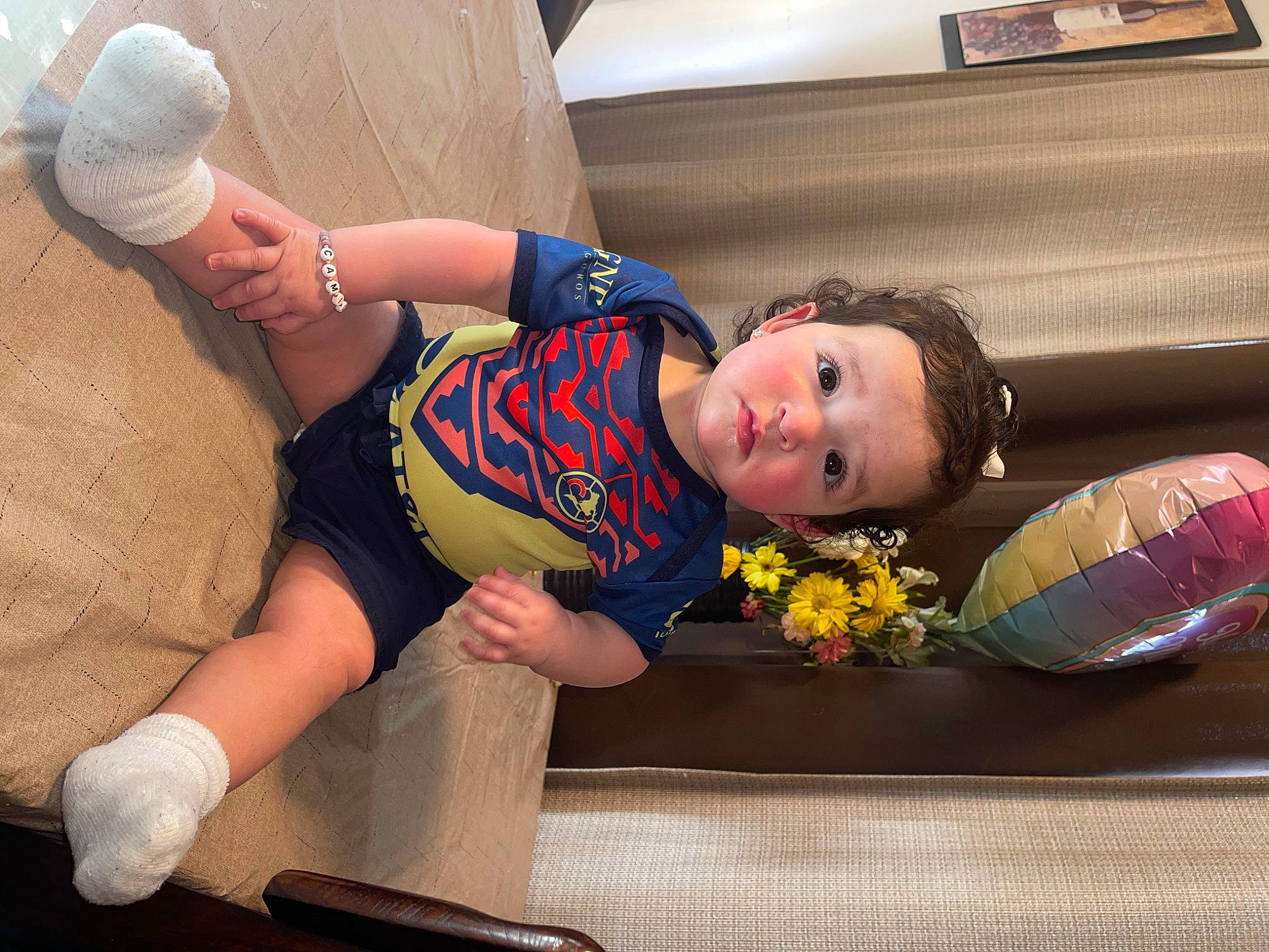 Camila is registered to the contest to win money with this photo: abdomen, arm, cap, comfort, elbow, facial_expression, fun, hairstyle, happy, hat, headgear, joint, knee, leg, leisure, mouth, muscle, person, thigh, toddler