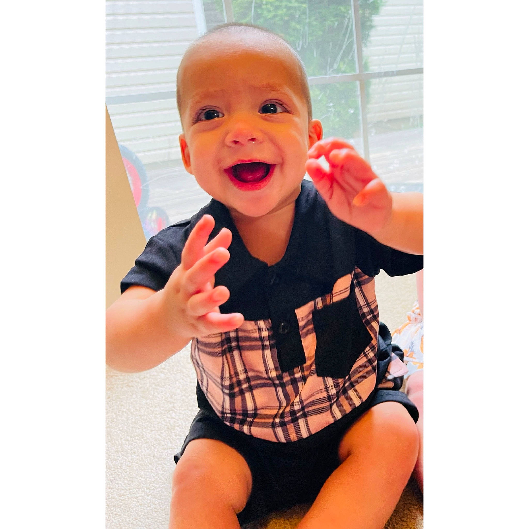 Sammuel is registered to the contest to win money with this photo: baby, baby_toddler_clothing, collar, comfort, elbow, eye, face, finger, gesture, happy, leg, mouth, neck, orange, person, shorts, sleeve, smile, t_shirt, thumb