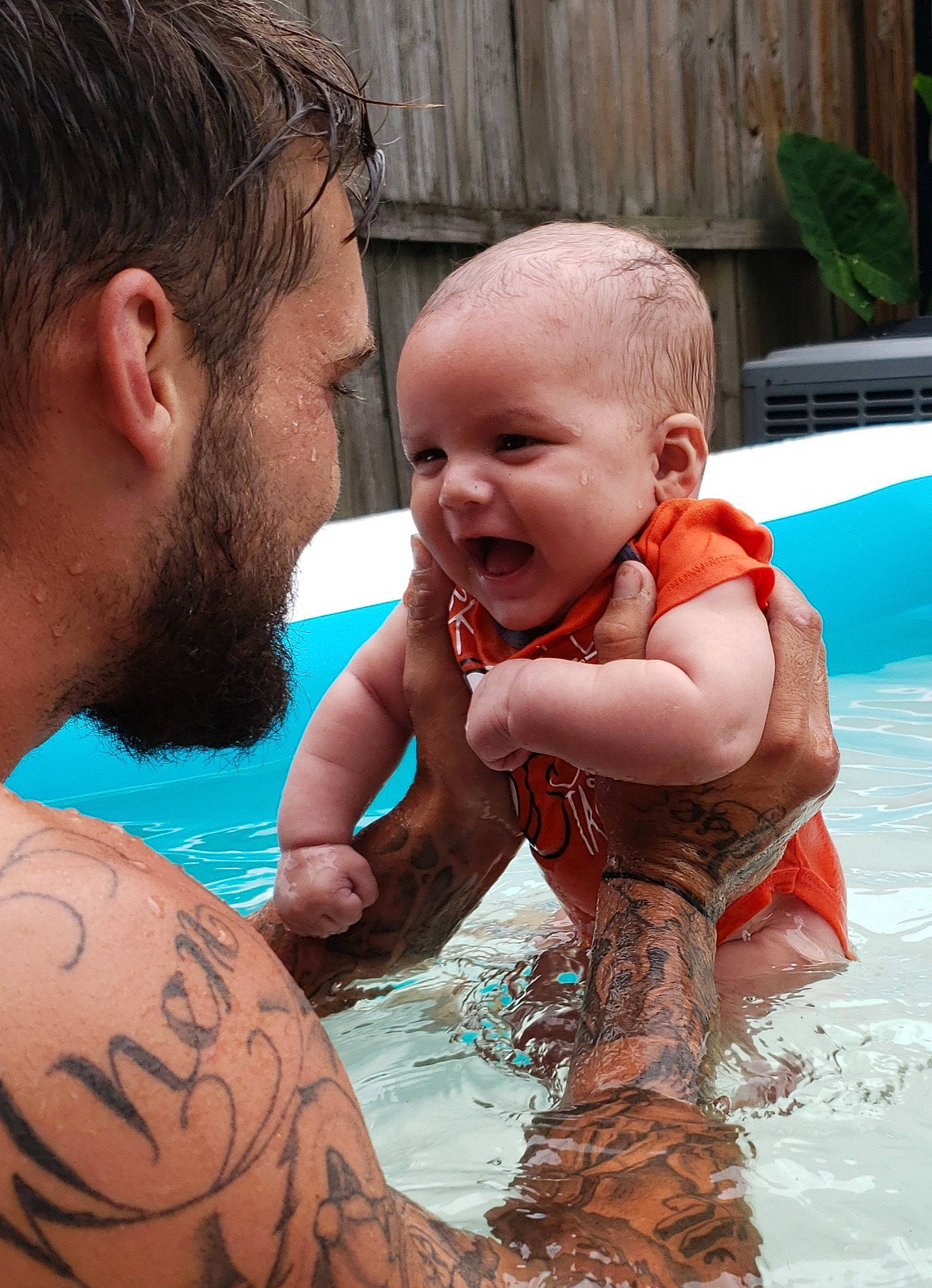 Kadyn is registered to the contest to win money with this photo: baby, barechested, bathing, chest, child, father, fun, leisure, male, mother, muscle, person, skin, smile, summer, swimming_pool, tattoo, toddler, vacation, water