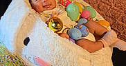 Cataleyah joined the competition — help win amazing prizes! baby, bunny_ears, celebration, child, colorful, cushion, cute, decorations, easter_basket, easter_eggs, festive, holiday, indoors, infant, lying_down, pink_socks, plush, smiling, soft_texture, toy
