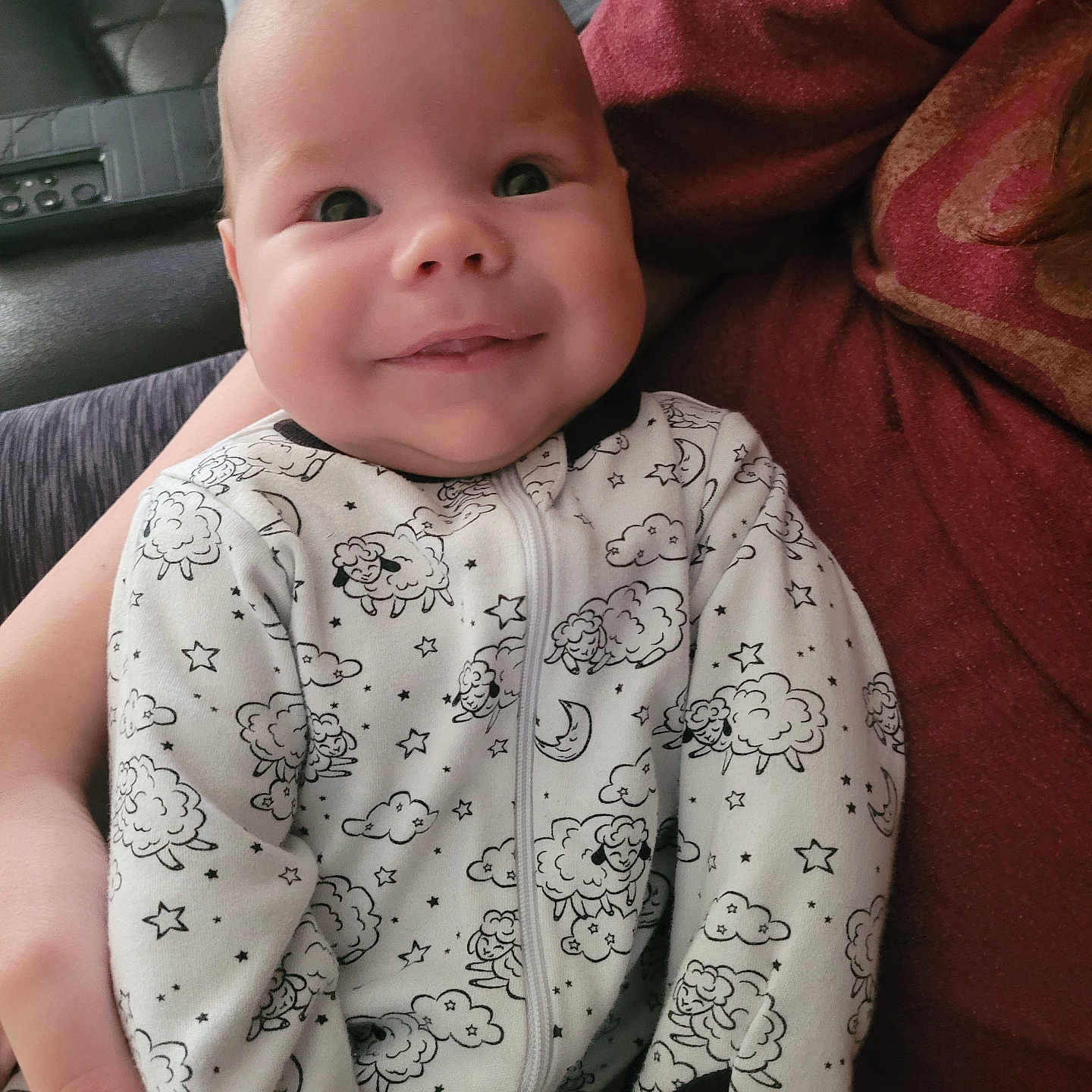 Asher is registered to the contest to win money with this photo: baby, blanket, bodypart, clothing, couch, cushion, dress, face, finger, furniture, hand, happy, head, homedecor, newborn, pattern, person, photography, portrait, smile