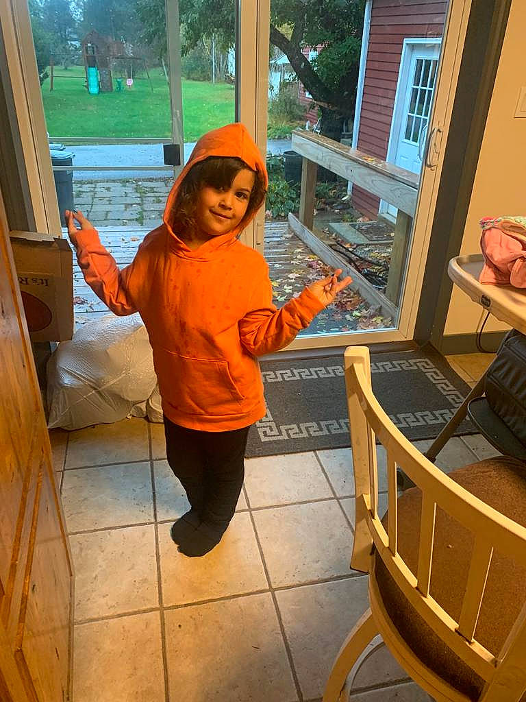 Sapphire is registered to the contest to win money with this photo: chair, door, floor, flooring, fun, happy, joy, leisure, orange, person, plant, porch, pumpkin, room, sitting, smile, t_shirt, tree, vacation, vegetable