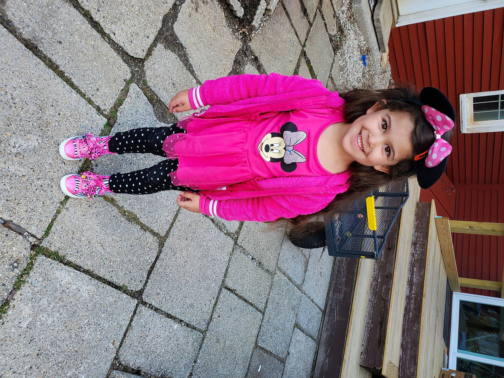 Sapphire is registered to the contest to win money with this photo: baby_toddler_clothing, child, costume, fence, flooring, fun, headwear, house, jacket, joy, leisure, magenta, pattern, person, pink, purple, sidewalk, smile, sneakers, street_fashion