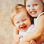 Anya joined the competition — help win amazing prizes! children, siblings, toddler, preschooler, smiling, laughing, happy, hugging, cuddling, portrait, indoors, close_up, blonde_hair, young_faces, family, sitting, pink_shirt, blue_clothing, warm_lighting, black_border