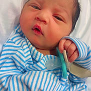 Azman joined the competition — help win amazing prizes! newborn, baby, infant, pacifier, striped_clothing, sleepy, hand, face, cute, soft, blanket, portrait, resting, indoors, child, person, small_hands, wearing, blue, white