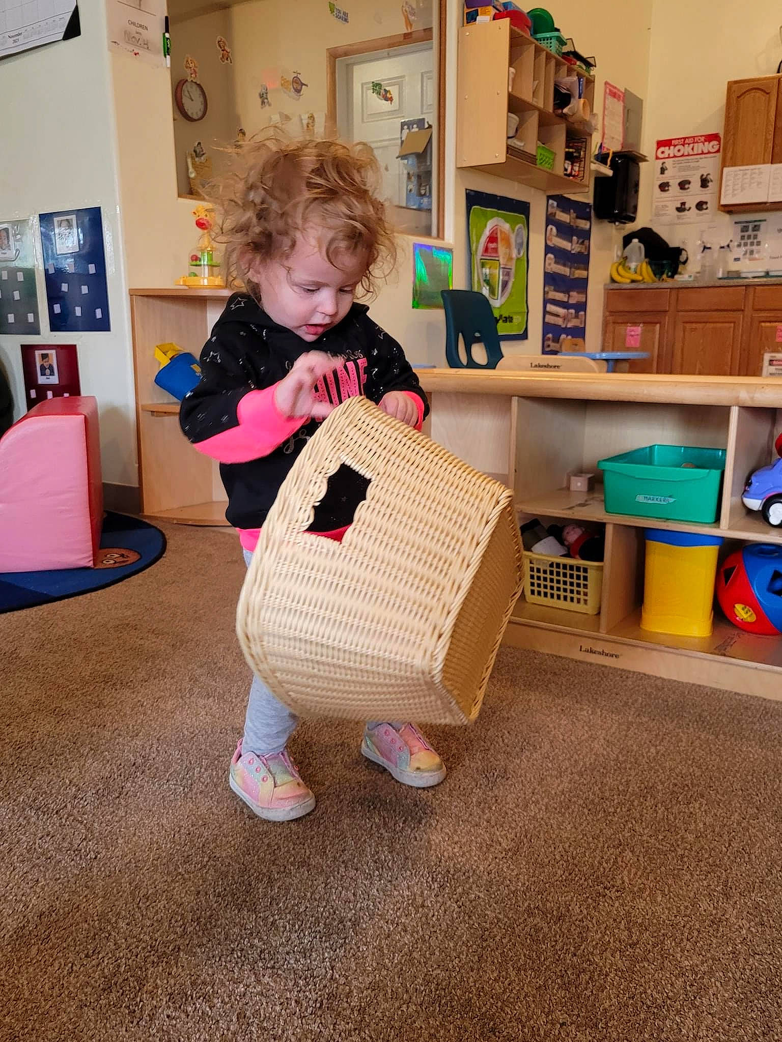Jocelynn is registered to the contest to win money with this photo: baby_products, baby_toddler_clothing, bag, cardboard, child, floor, flooring, fun, hardwood, household_supply, luggage_and_bags, pattern, person, picture_frame, play, room, shelf, standing, textile, toddler