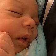 Zamir is registered to the contest to win money with this photo: baby, sleeping, blanket, blue, close_up, infant, face, hand, soft, peaceful, indoors, newborn, portrait, video_call, technology, skin, cute, resting, child, young