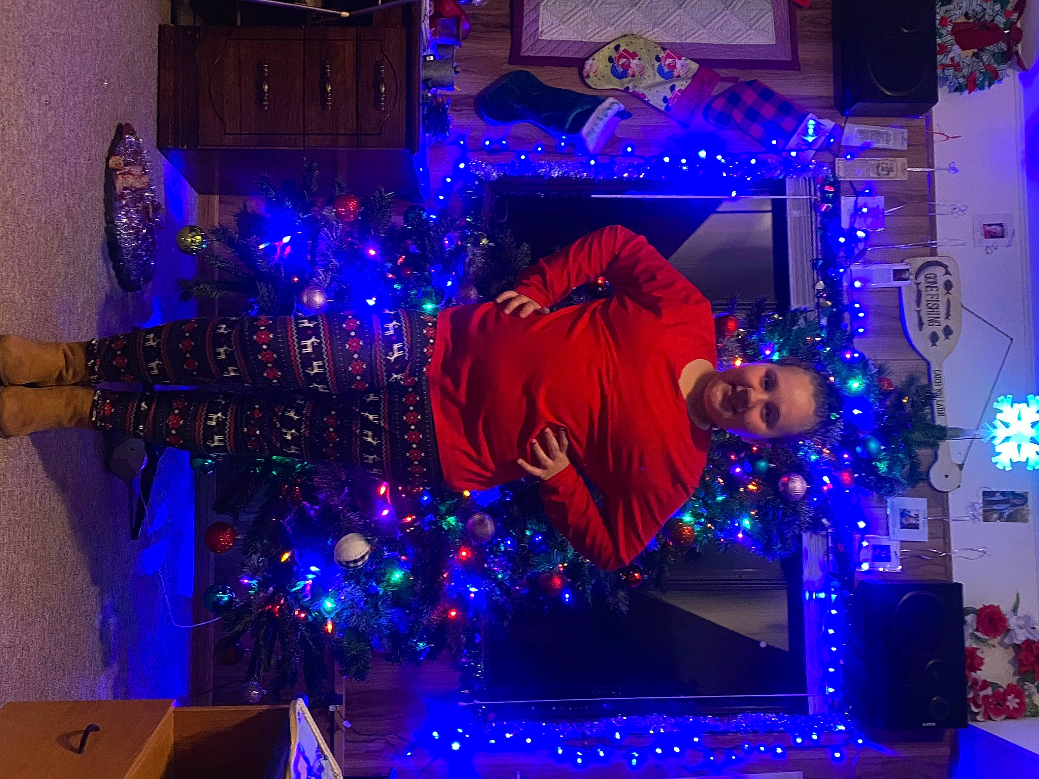 Charlie is registered to the contest to win money with this photo: blue, christmas, christmas_decoration, christmas_ornament, decoration, electric_blue, entertainment, event, fun, holiday, interior_design, joy, light, magenta, ornament, person, plant, purple, space, tree