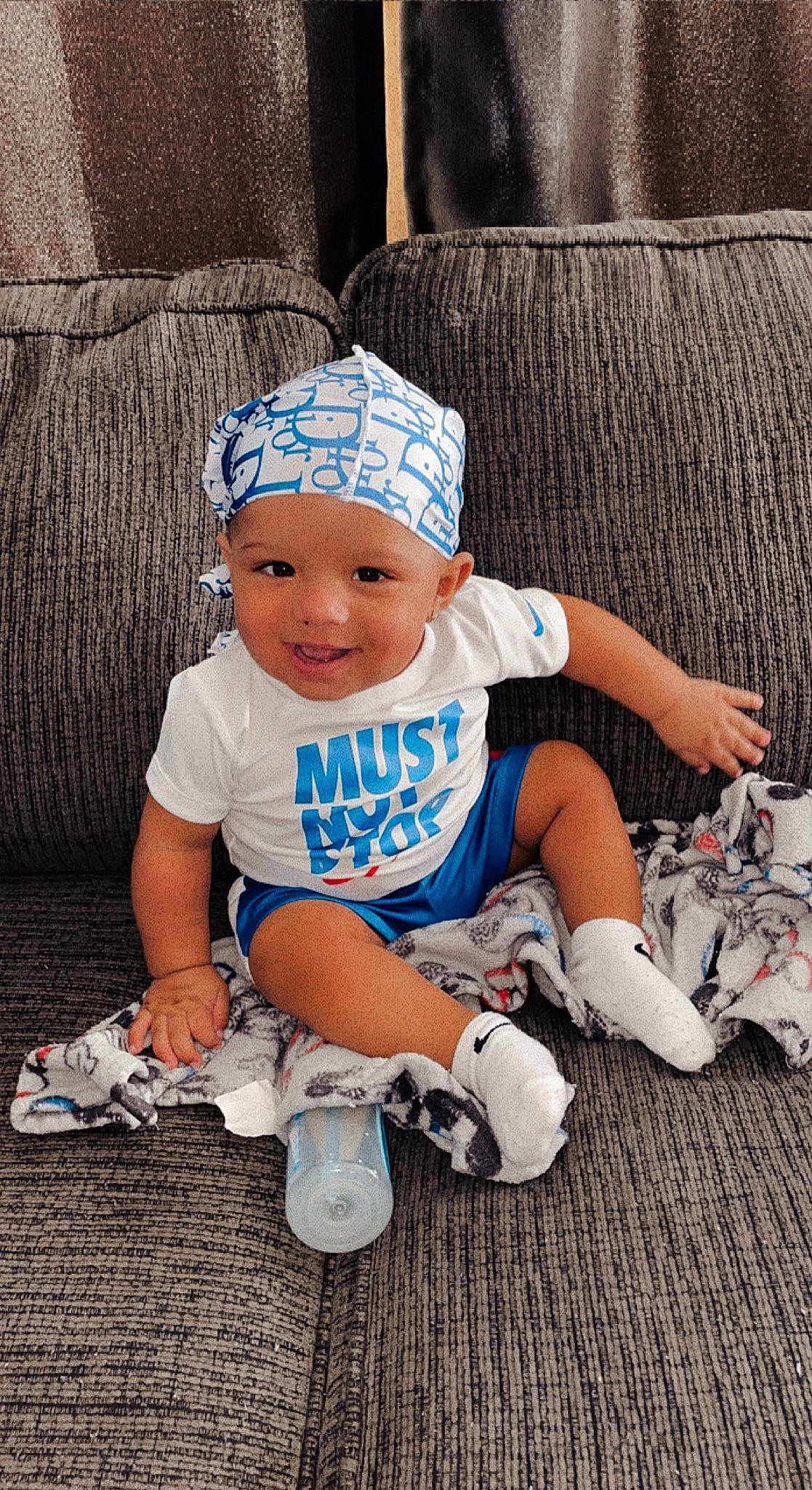 Taveare Jr joined the competition — help win amazing prizes! azure, baby, baby_toddler_clothing, cap, child, cool, couch, electric_blue, fun, happy, hat, headgear, headwear, human_leg, joy, knee, pattern, person, product, sitting
