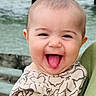 baby, child, cute, expression, face, fun, happy, head, infant, joyful, nature, outdoor, patterned_clothing, person, pier, smiling, toddler, tongue_out, water, wood