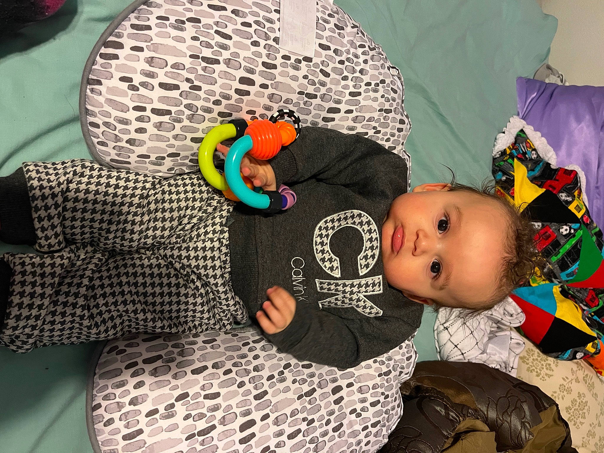 Jiraiya is registered to the contest to win money with this photo: baby, baby_products, baby_toddler_clothing, beanie, child, comfort, fashion_accessory, hat, headgear, linens, pattern, person, personal_protective_equipment, play, room, sitting, sleeve, textile, toddler, tree