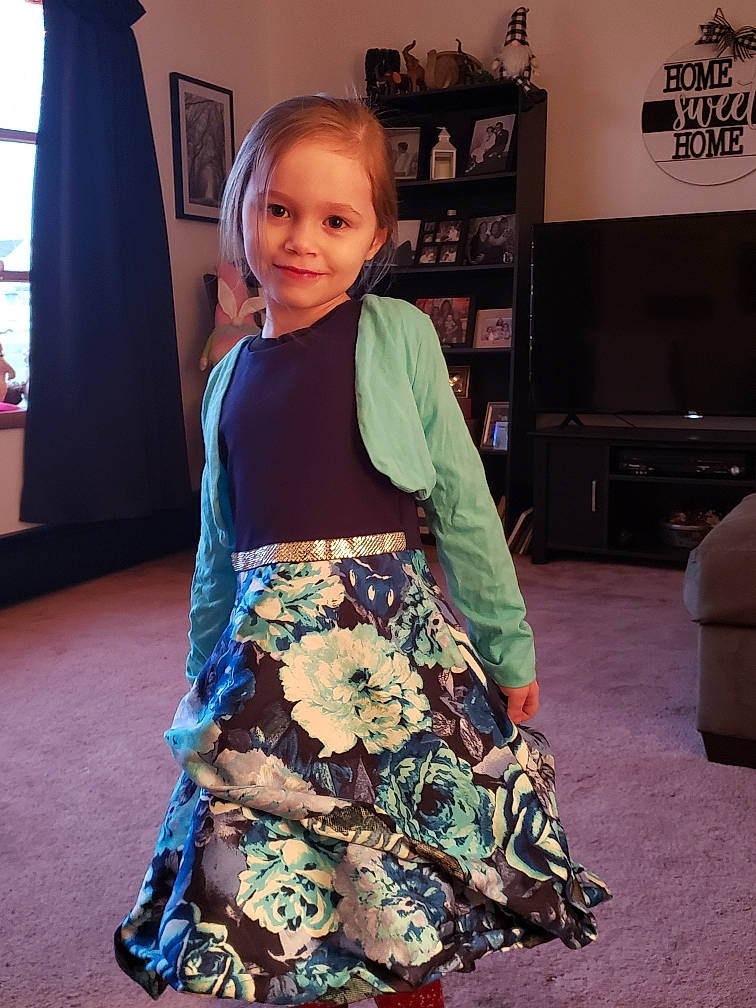 Remington is registered to the contest to win money with this photo: baby_toddler_clothing, child, curtain, electric_blue, fashion_design, flooring, happy, human_body, human_leg, joint, joy, pattern, person, shelf, sleeve, smile, standing, t_shirt, thigh, toddler