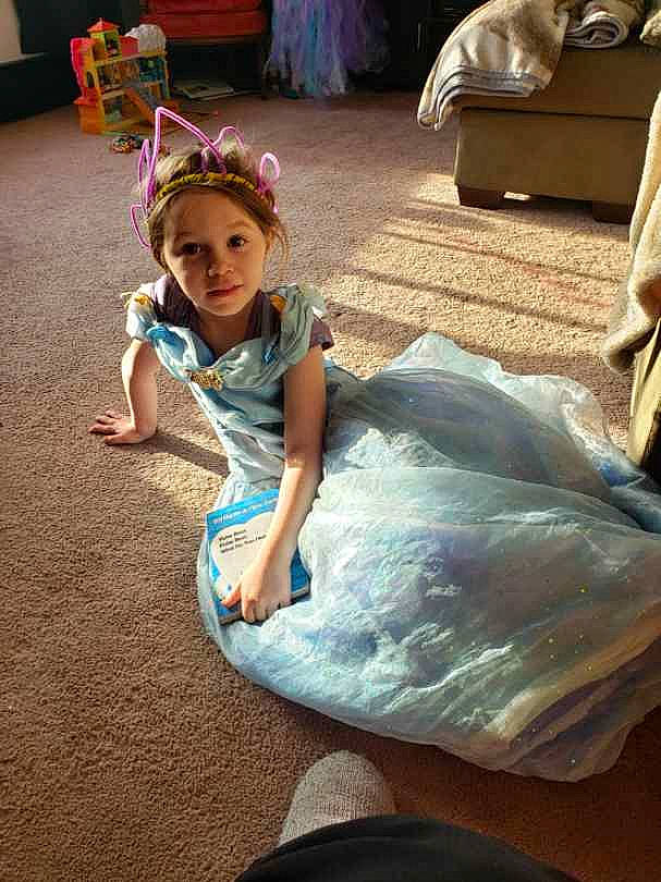 Remington is registered to the contest to win money with this photo: beauty, chair, child, costume, event, fashion_accessory, fun, hair, happy, leisure, lighting, magenta, party, person, play, recreation, sandal, sitting, smile, toddler