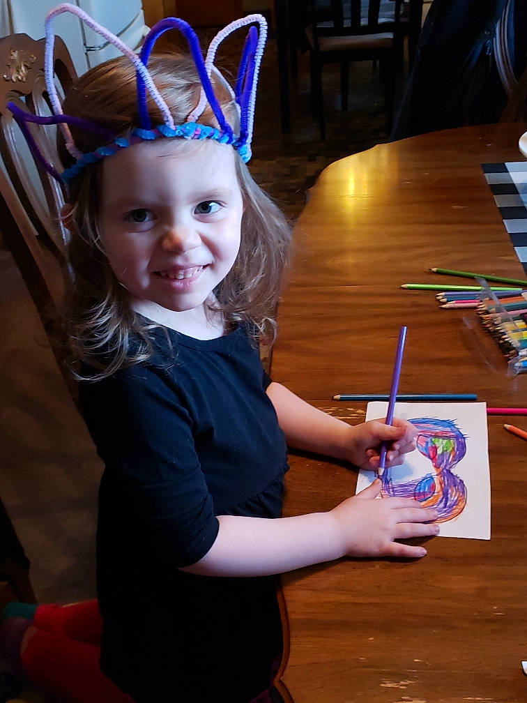 Killian is registered to the contest to win money with this photo: child, child_art, costume, costume_hat, desk, electric_blue, event, fashion_accessory, fun, hair_accessory, happy, headwear, holiday, joy, office_supplies, party_supply, pen, person, purple, smile
