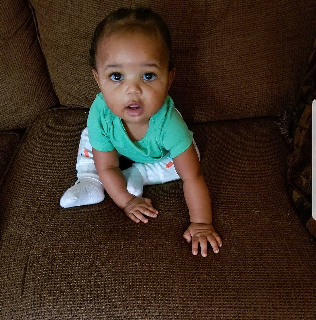 Diego joined the competition — help win amazing prizes! baby, baby_toddler_clothing, cheek, chin, clothing, comfort, face, floor, flooring, fun, grass, hair, hardwood, head, nose, person, skin, sleeve, t_shirt, toddler