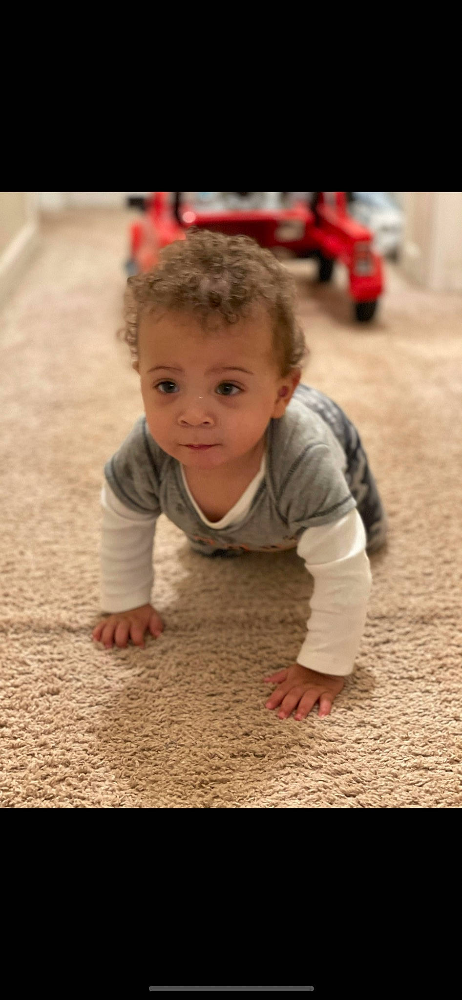 Jakari is registered to the contest to win money with this photo: asphalt, baby, cheek, child, crawling, eye, floor, flooring, fun, grass, hairstyle, happy, person, recreation, road_surface, sitting, skin, smile, soil, toddler