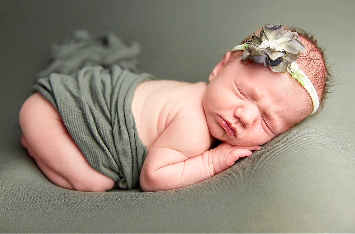 Raegan Rose is registered to the contest to win money with this photo: arm, baby, baby_toddler_clothing, cheek, child, comfort, dress, fashion_accessory, finger, flash_photography, grass, happy, headband, headgear, headpiece, headwear, jewellery, nail, person, skin