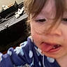 Elianna is registered to the contest to win money with this photo: child, face, tongue, hair, blue_clothing, polka_dots, bed, blanket, messy_room, indoor, person, close_up, young_child, pajamas, sleepwear, skin, expression, casual, home, portrait
