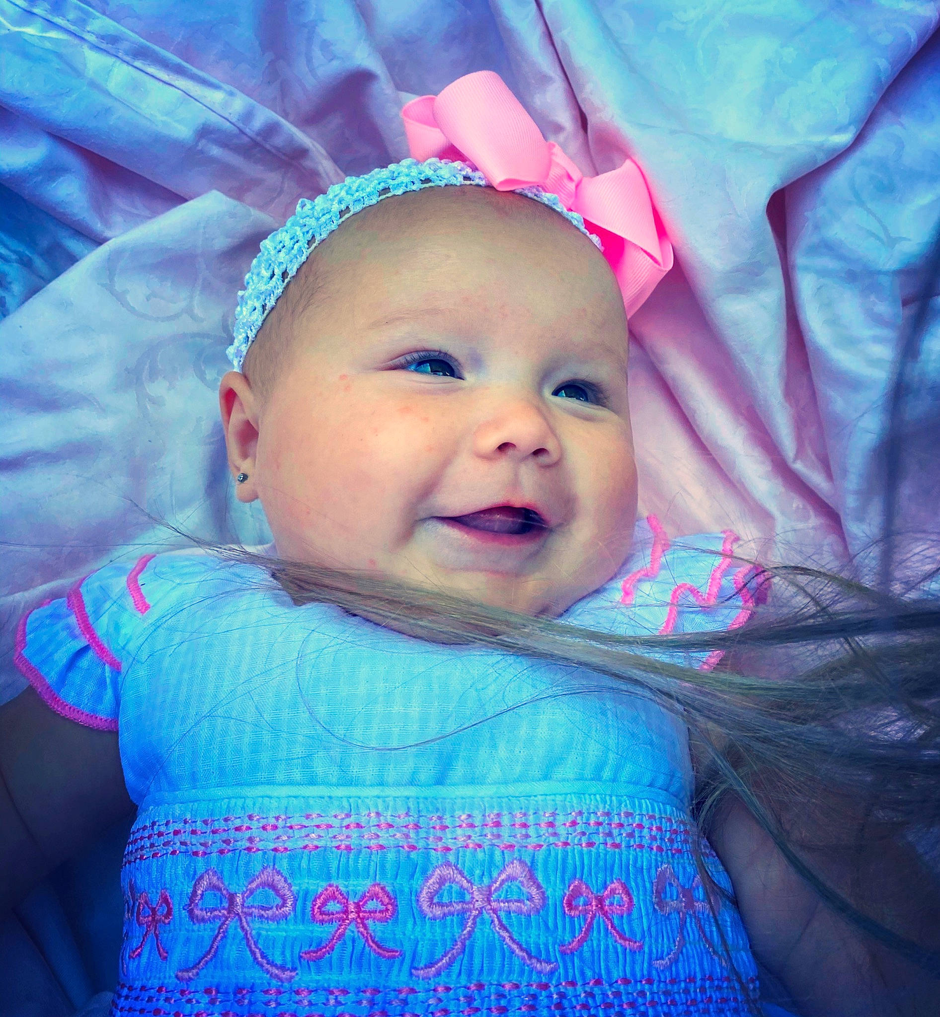 Kate is registered to the contest to win money with this photo: baby, blue, cheek, child, eye, eyebrow, face, facial_expression, forehead, fun, head, headwear, iris, lip, mouth, nose, person, pink, product, skin