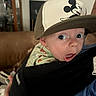 Callahan joined the competition — help win amazing prizes! baby, infant, child, face, portrait, wide_eyes, surprised, open_mouth, mickey_mouse, cap, hat, carrier, baby_carrier, indoor, home, couch, adult, clothing, close_up, photography