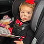 accessories, baby, bodypart, car, car_interior, carseat, clothing, cushion, face, finger, hand, head, homedecor, person, photography, portrait, reading, text, transportation, vehicle