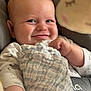 Kairo is registered to the contest to win money with this photo: baby, smile, blanket, plush_toy, infant, face, hand, clothing, cute, closeup, indoors, child, happy, cozy, soft_toy, expression, portrait, seat, comfort, playful
