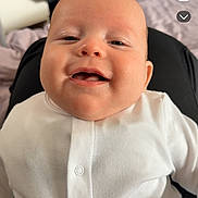Kairo is registered to the contest to win money with this photo: baby, infant, smile, white_clothing, indoors, person, face, happy, portrait, closeup, child, sitting, lap, buttoned_shirt, polka_dot, furniture, blurred_background, skin, head, casual_photo