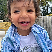 Nirvair joined the competition — help win amazing prizes! child, toddler, smiling, face, hair, blue_shirt, white_tshirt, outdoor, greenery, yellow_chair, happy, portrait, person, casual_clothing, cute, young_child, sitting, daylight, closeup, nature