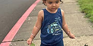 Nirvair joined the competition — help win amazing prizes! toddler, child, sidewalk, leaves, tank_top, pants, sandals, footwear, outdoor, walking, parking_lot, cars, grass, bracelet, hair, person, summer_clothing, nature, daytime, concrete