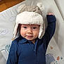 baby, child, hat, bear_hat, blue_shirt, play_mat, elephant, plants, raised_arm, smiling, face, indoor, cute, cozy, infant, portrait, person, headwear, expression, soft_texture